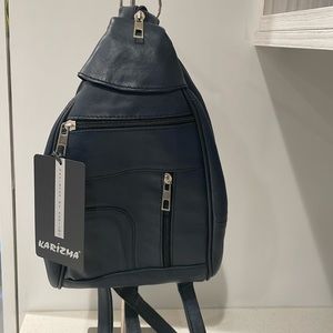New. Never used, use as a crossbody bag also converts into a small backpack.